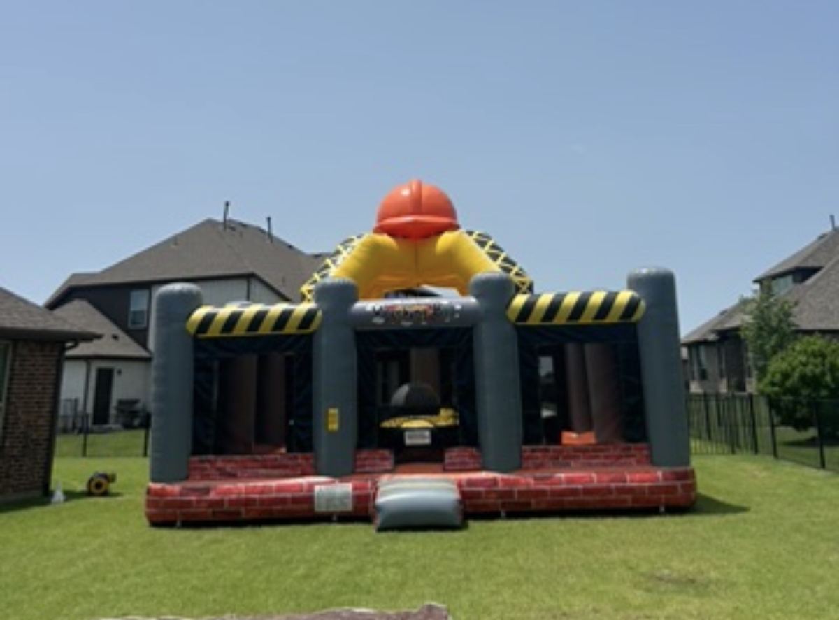 Construction-themed wrecking ball interactive inflatable set up on grass in a Gunter, TX backyard
