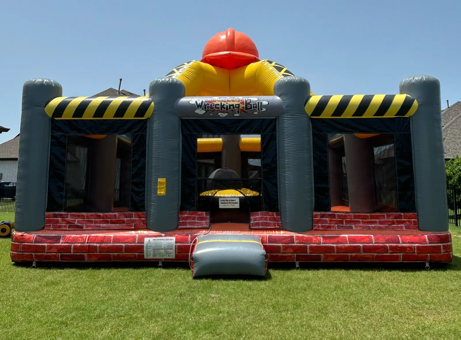 Construction-themed wrecking ball interactive inflatable set up on grass in a Gunter, TX backyard